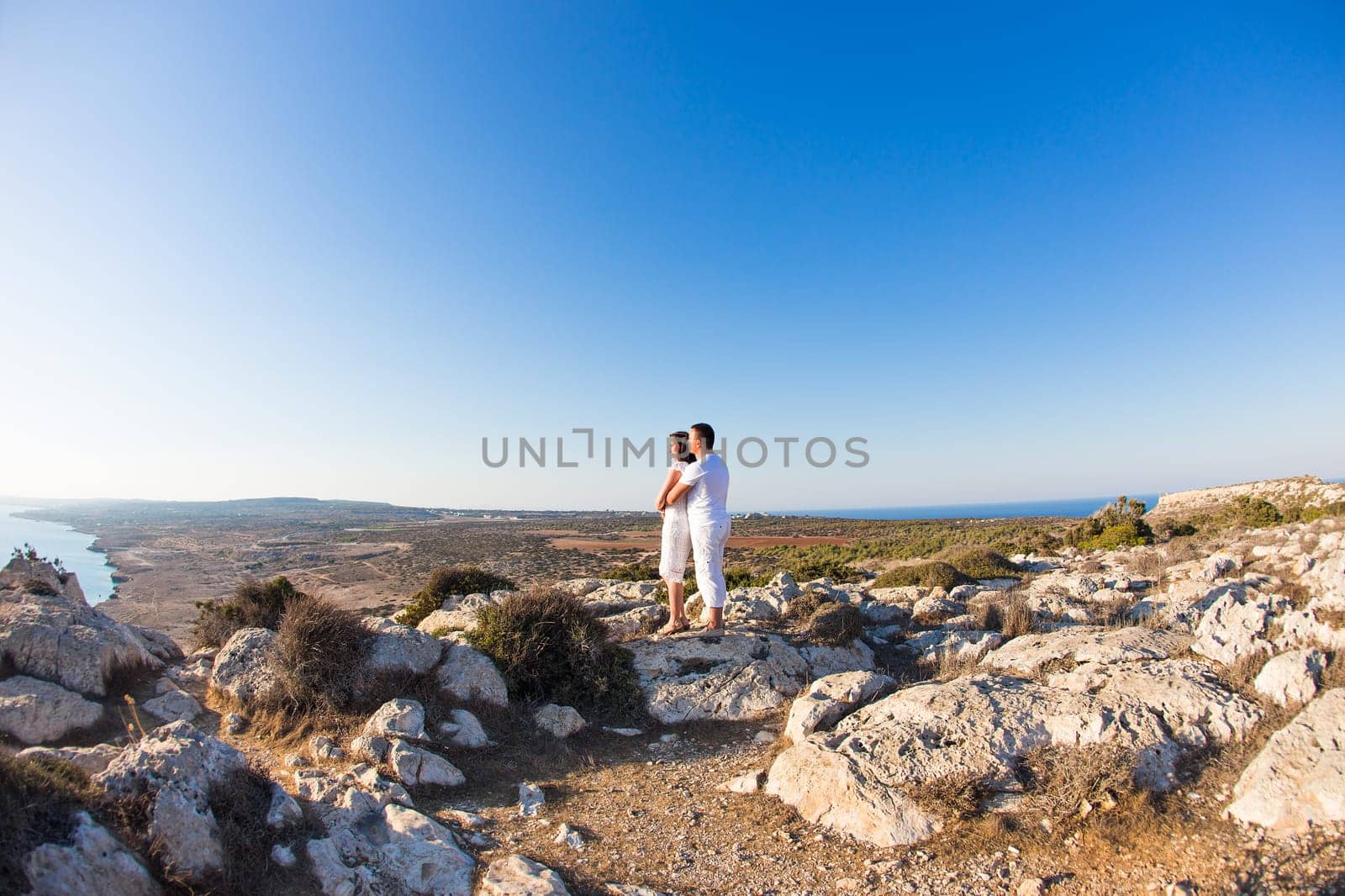 couple of young men and woman hugging and looking at the distance