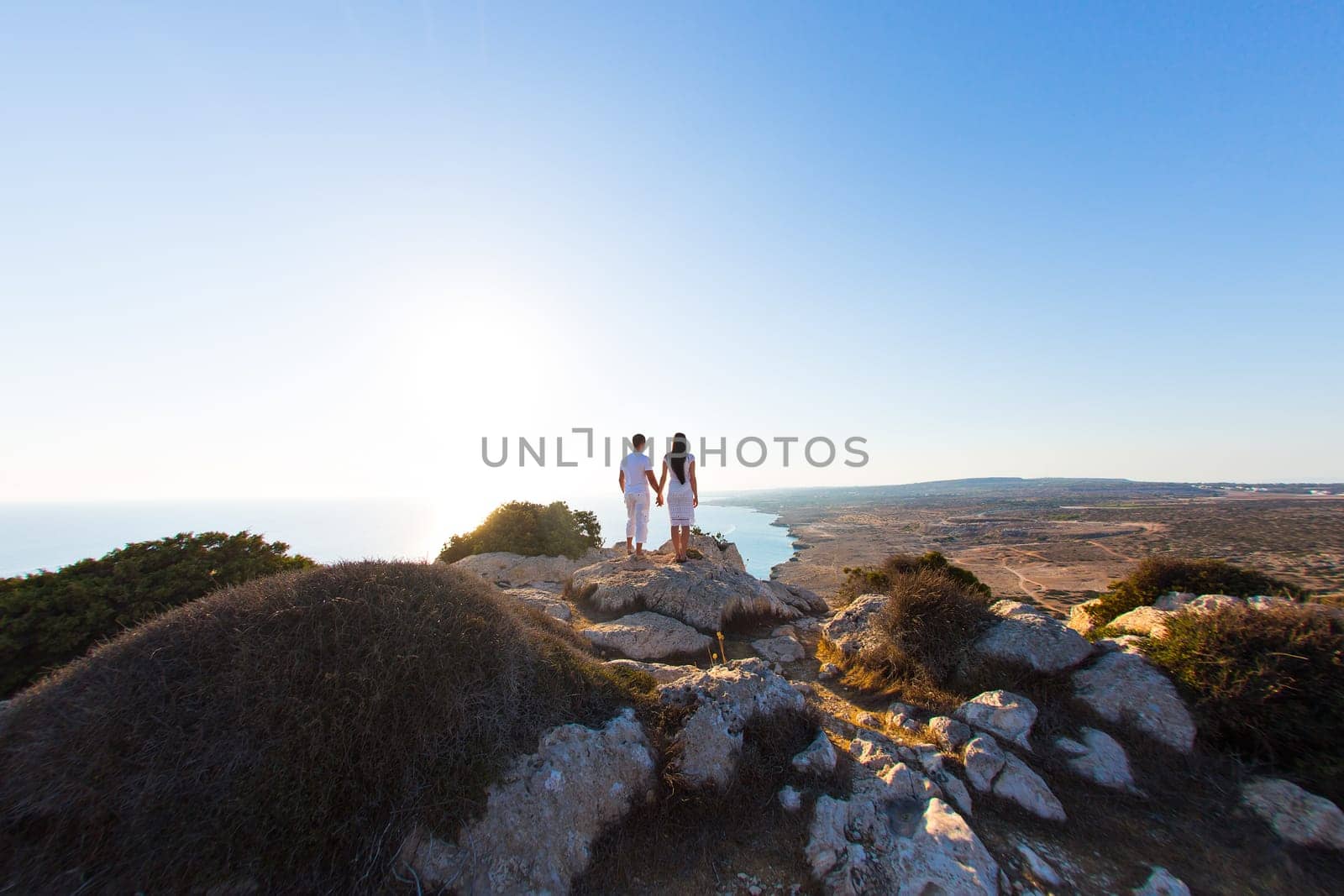 couple of young men and woman hugging and looking at the distance