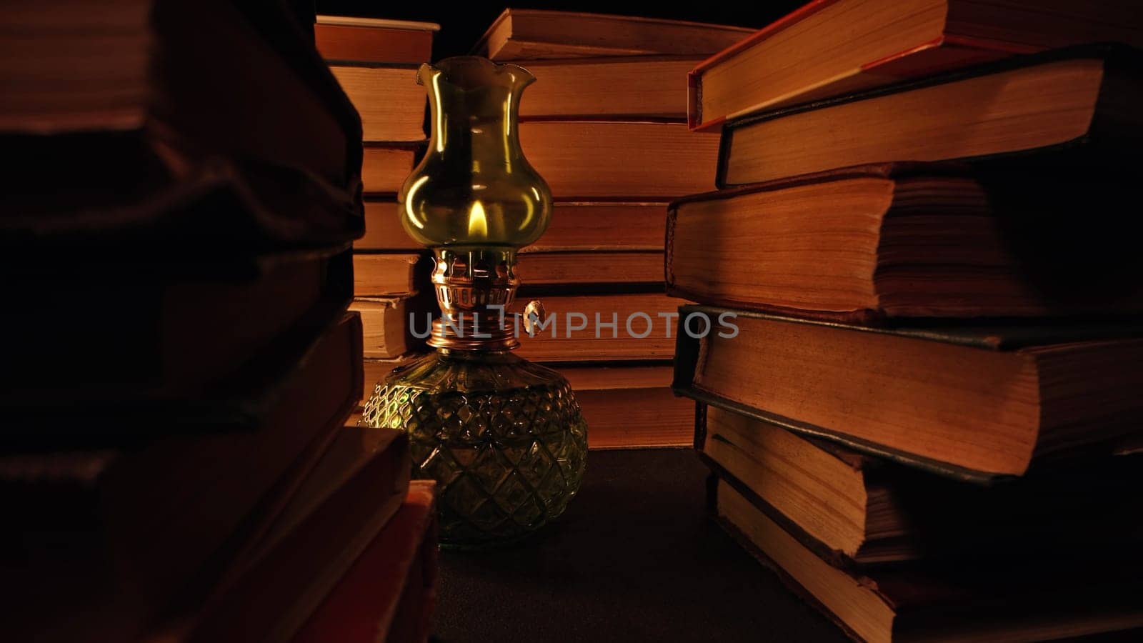 Gas lamp near stack of old books, slider footage in antique shop, bookstore. by kristina_kokhanova