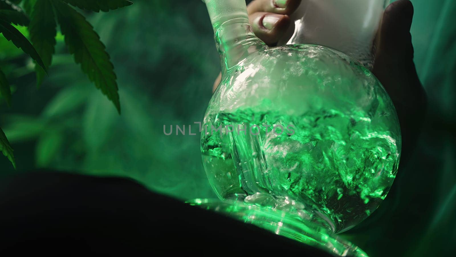 Smoking medical marijuana, glass water bong in neon light at home. Cannabis. High quality photo