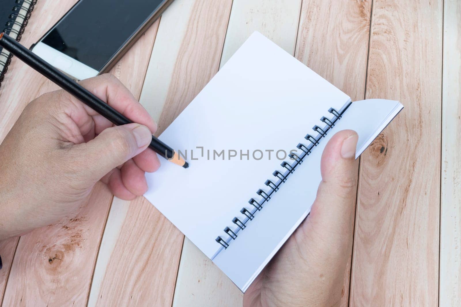 Businessman hands with pen writing notebook on office desk. Copy space. Business concept.