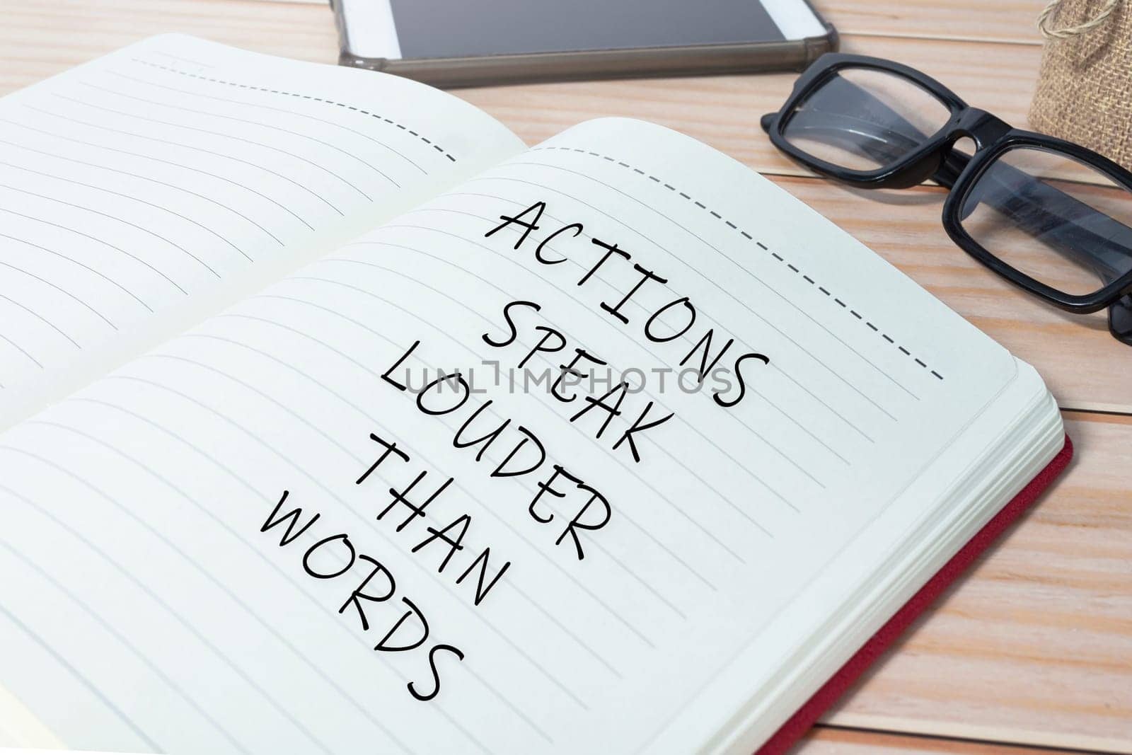 Actions speak louder than words text on notepad. Business mindset concept.