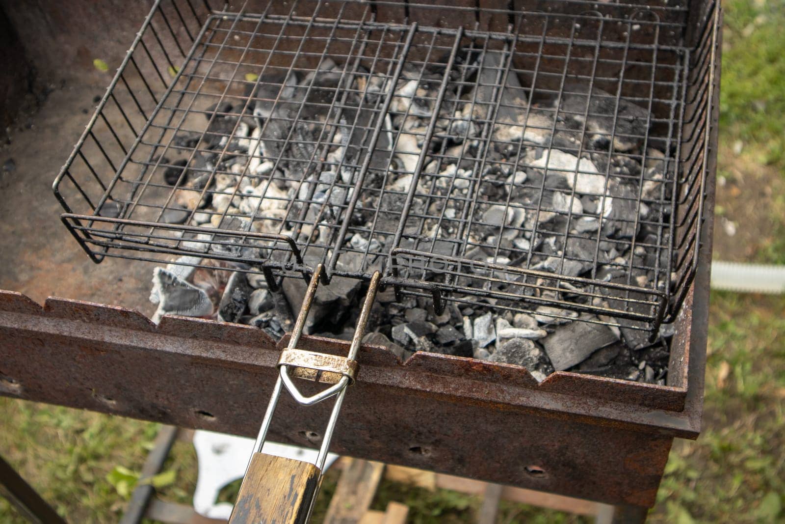 Close-up of a barbecue grill with burnt coals without fire, after cooking.