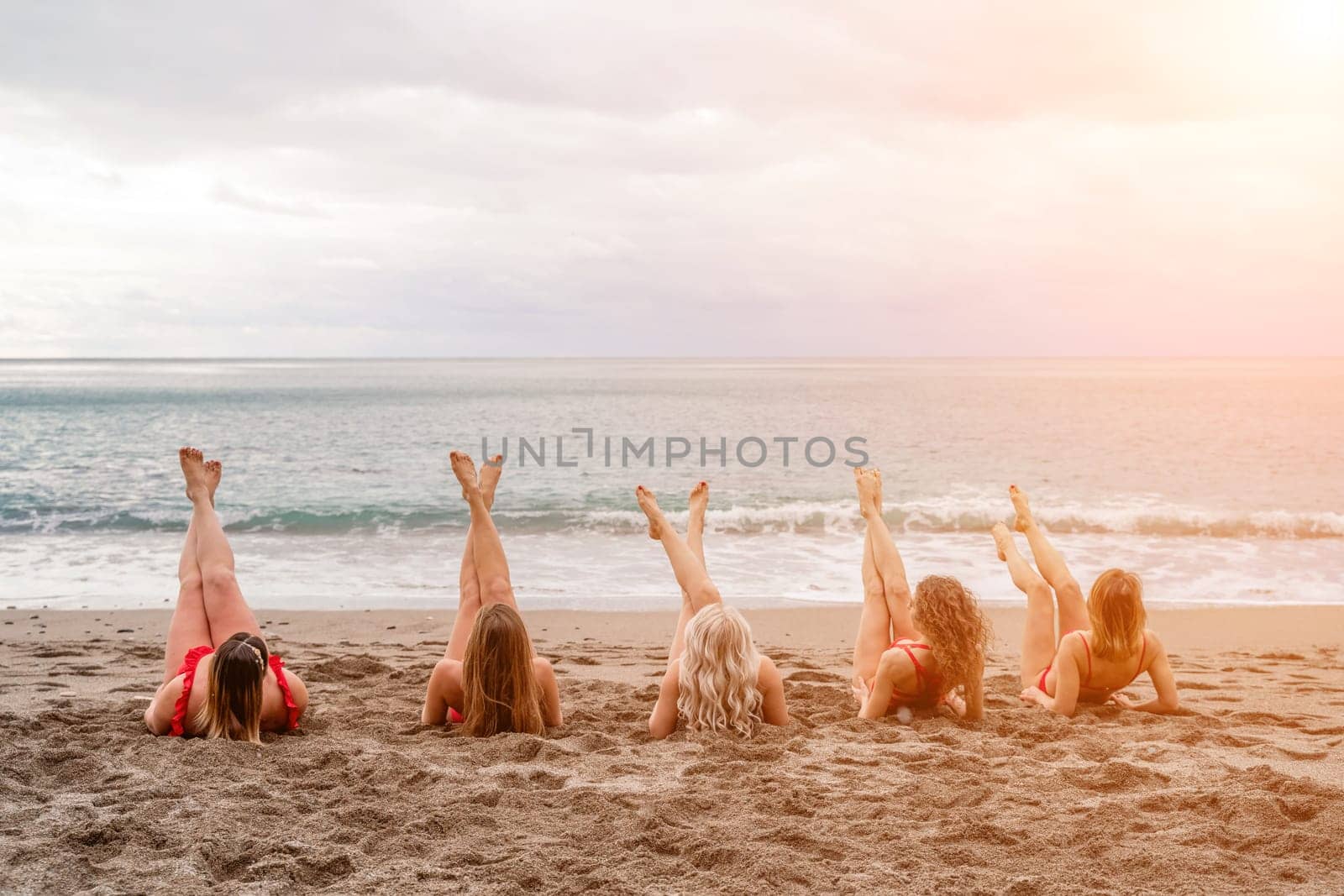 Big happy family or group of five friends is having fun against sunset beach. Beach holidays concept