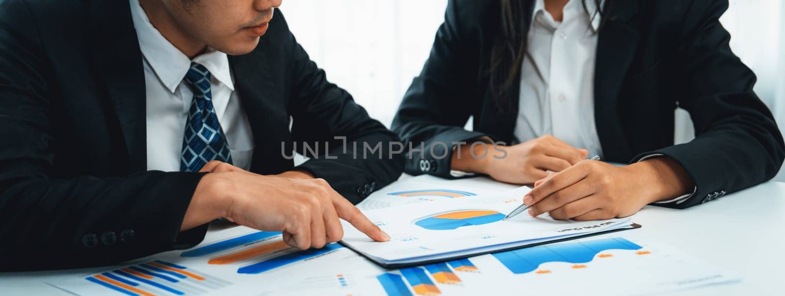 Business people in group meeting in formal attire share idea discussing report for company profit in creative workspace for start up business shot in close up view on group meeting table . Oratory .