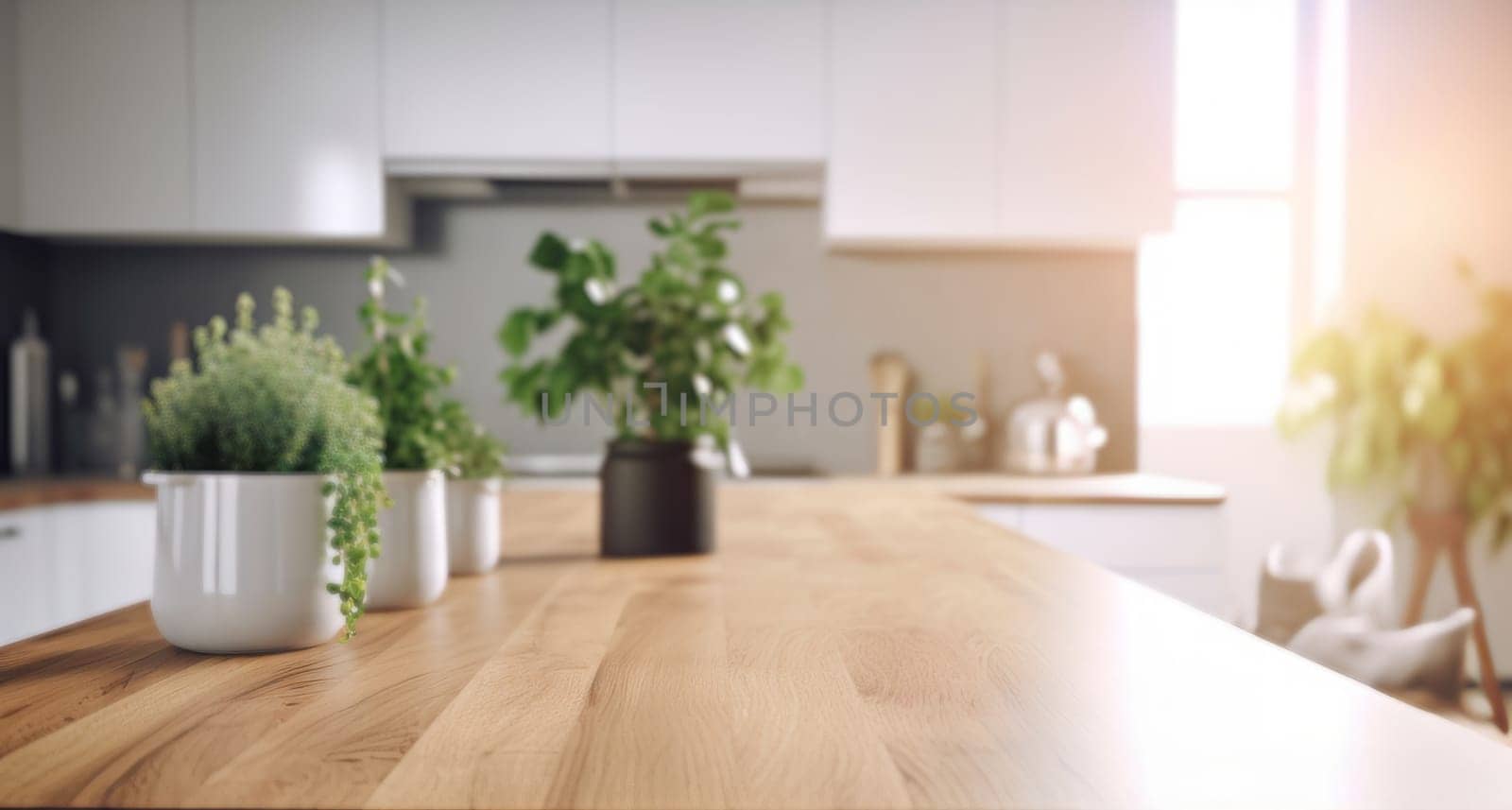 Blurred interior of a white modern kitchen with window, wooden countertop with a green plants.