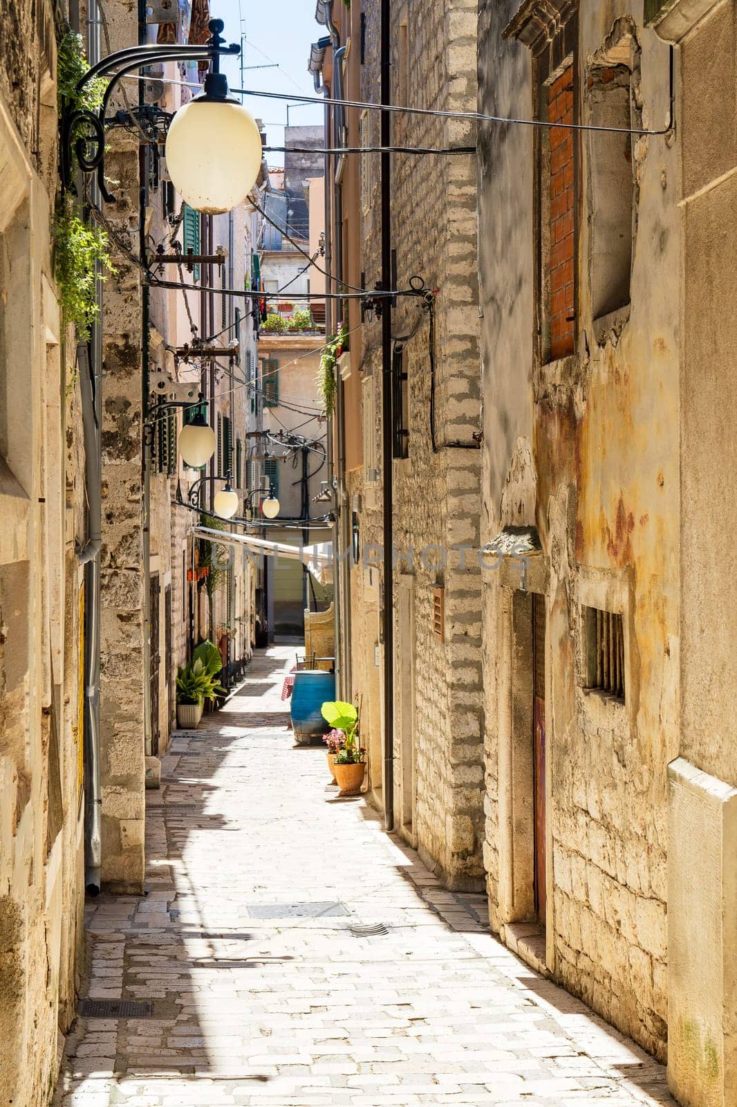 Small narrow street in the old town of sibenik in croatia. Sibenik Tourist city by the Adratic sea by PhotoTime