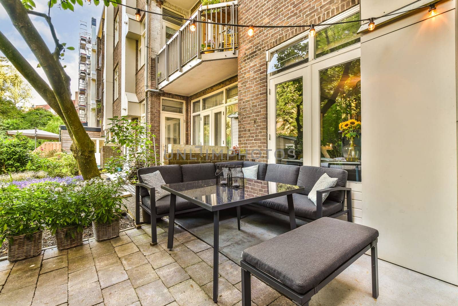 a patio with a table and chairs and a window by casamedia