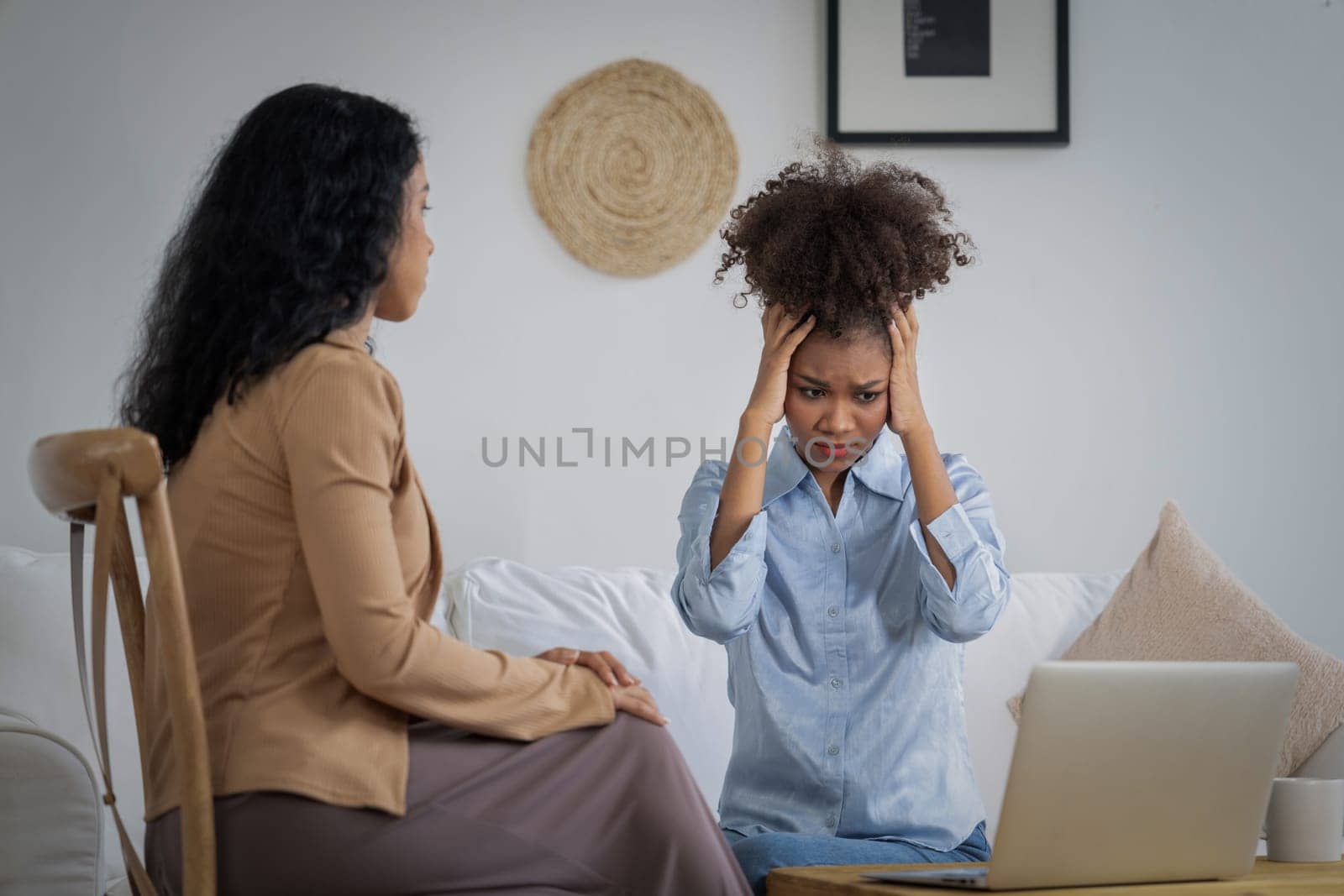 Sad PTSD woman patient in crucial therapy for mental health with psychologist, depression or grief after life failure. Frustrated trauma young woman talking to a psychologist about emotion in clinic