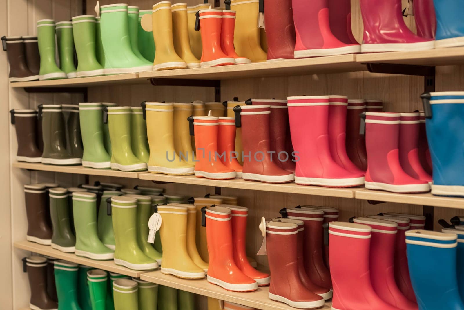 Rubber boots of different colors on store shelves