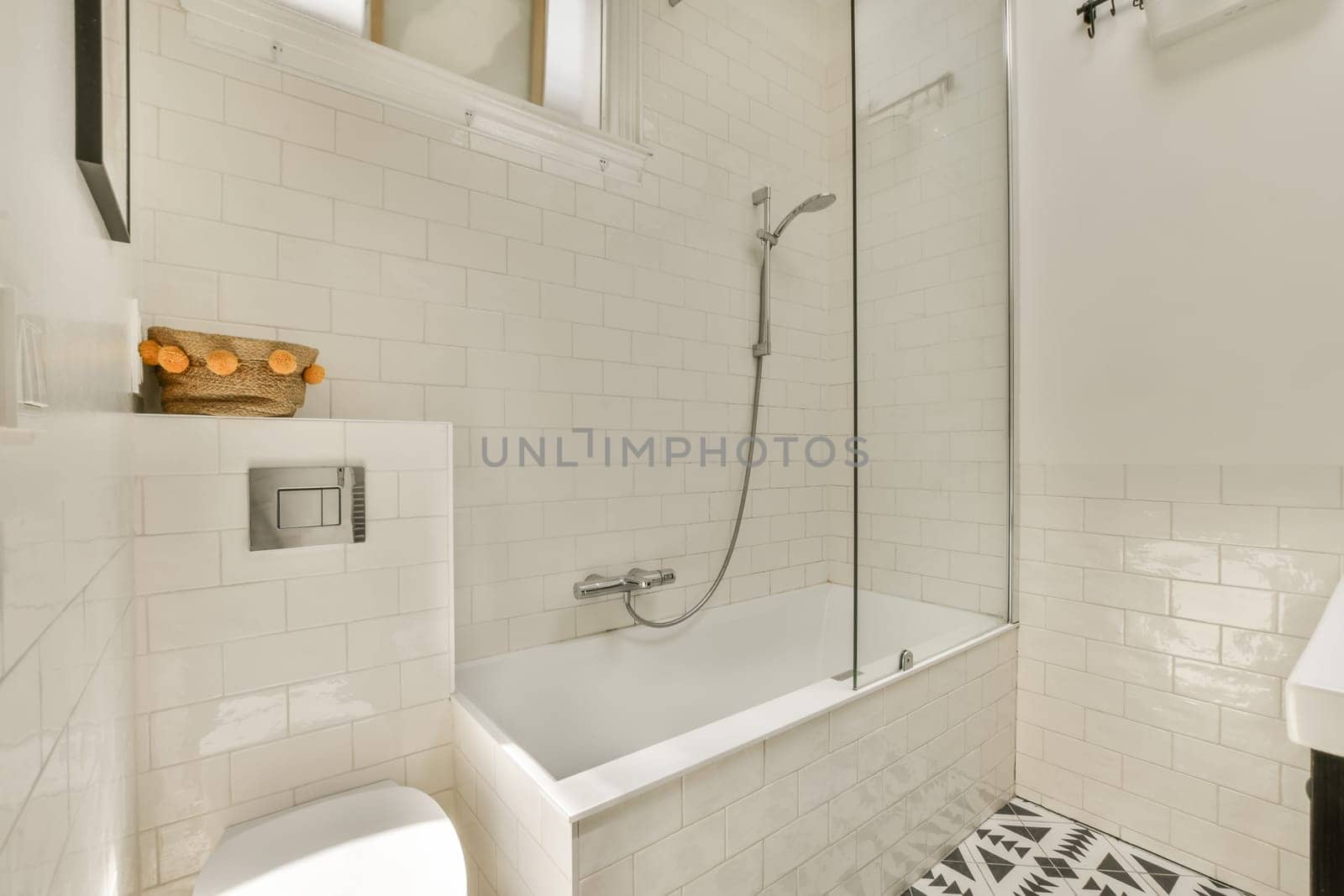 a white bathroom with black and white patterned floor tiles on the walls, along with a walk - in shower
