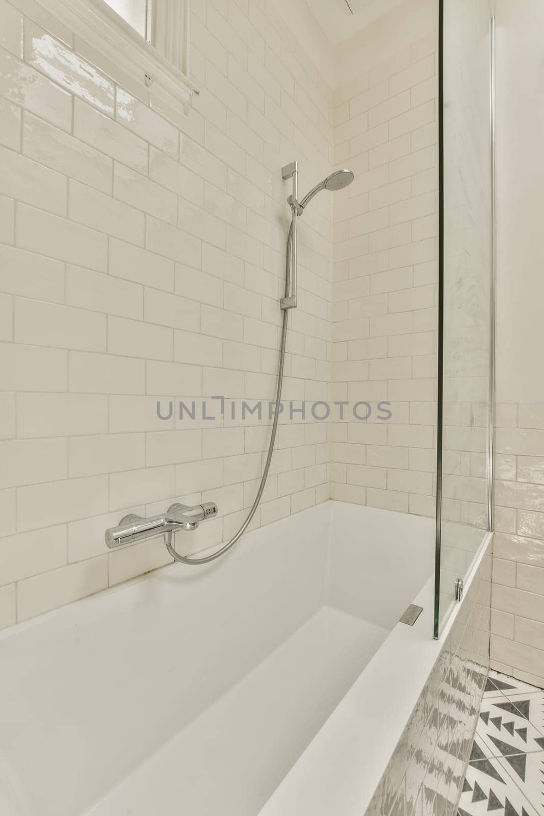 a white tub with a shower in a white bathroom by casamedia
