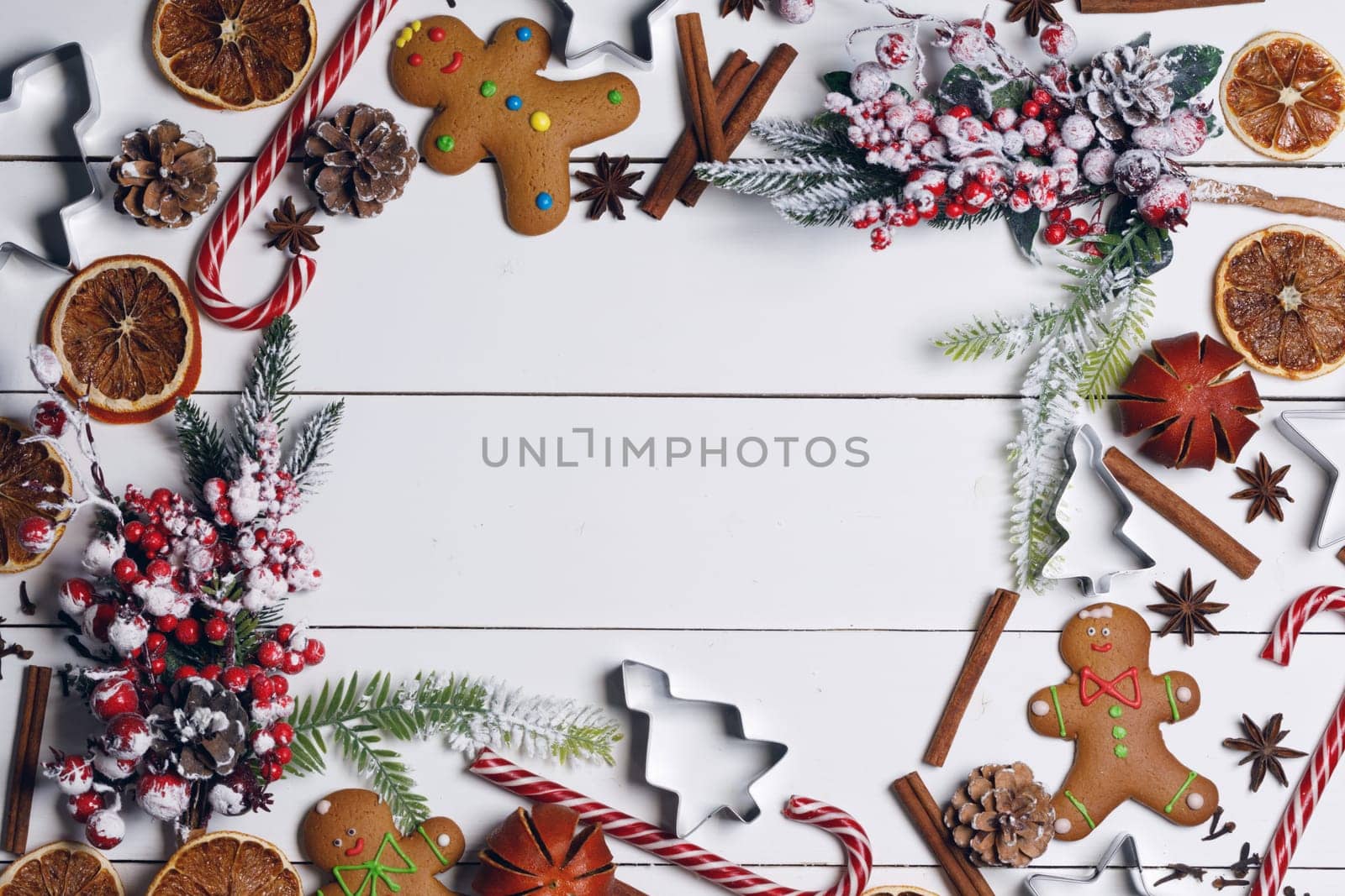 Christmas flat lay background with traditional gingerbread cookies dried orange cinnamon on wood , copy space for text