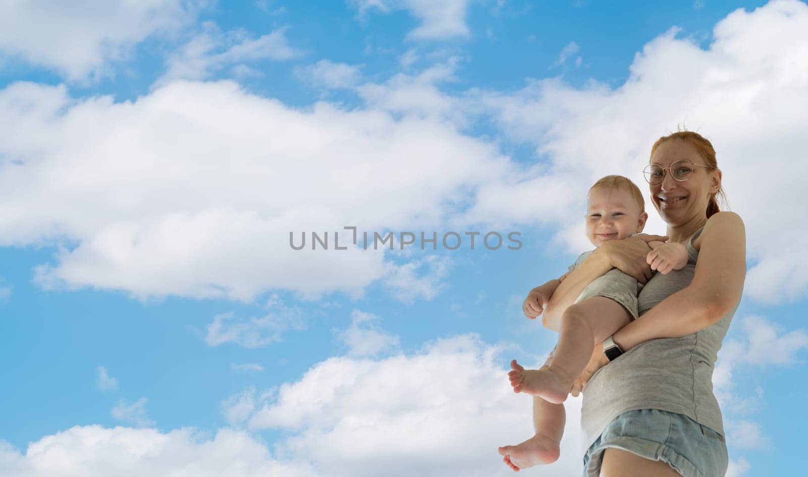 Mother with child in front of cloudy sky - white hair persons by Studia72