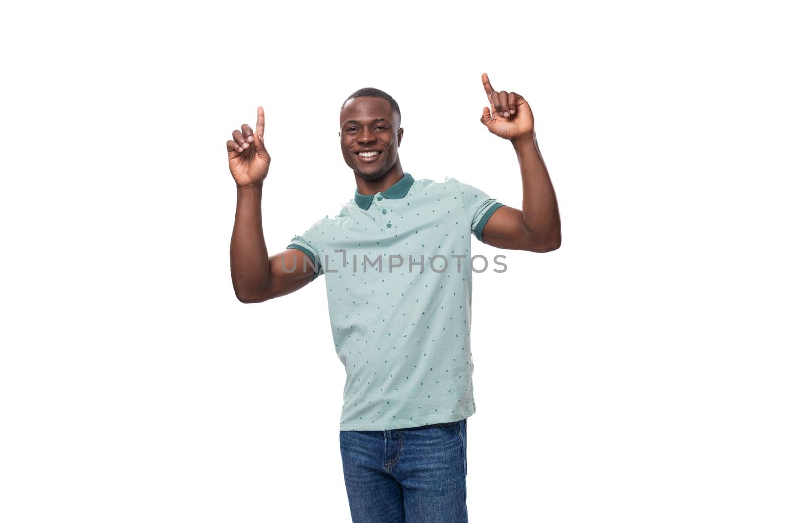 young smart american guy dressed in a mint t-shirt tells the news and points his finger.