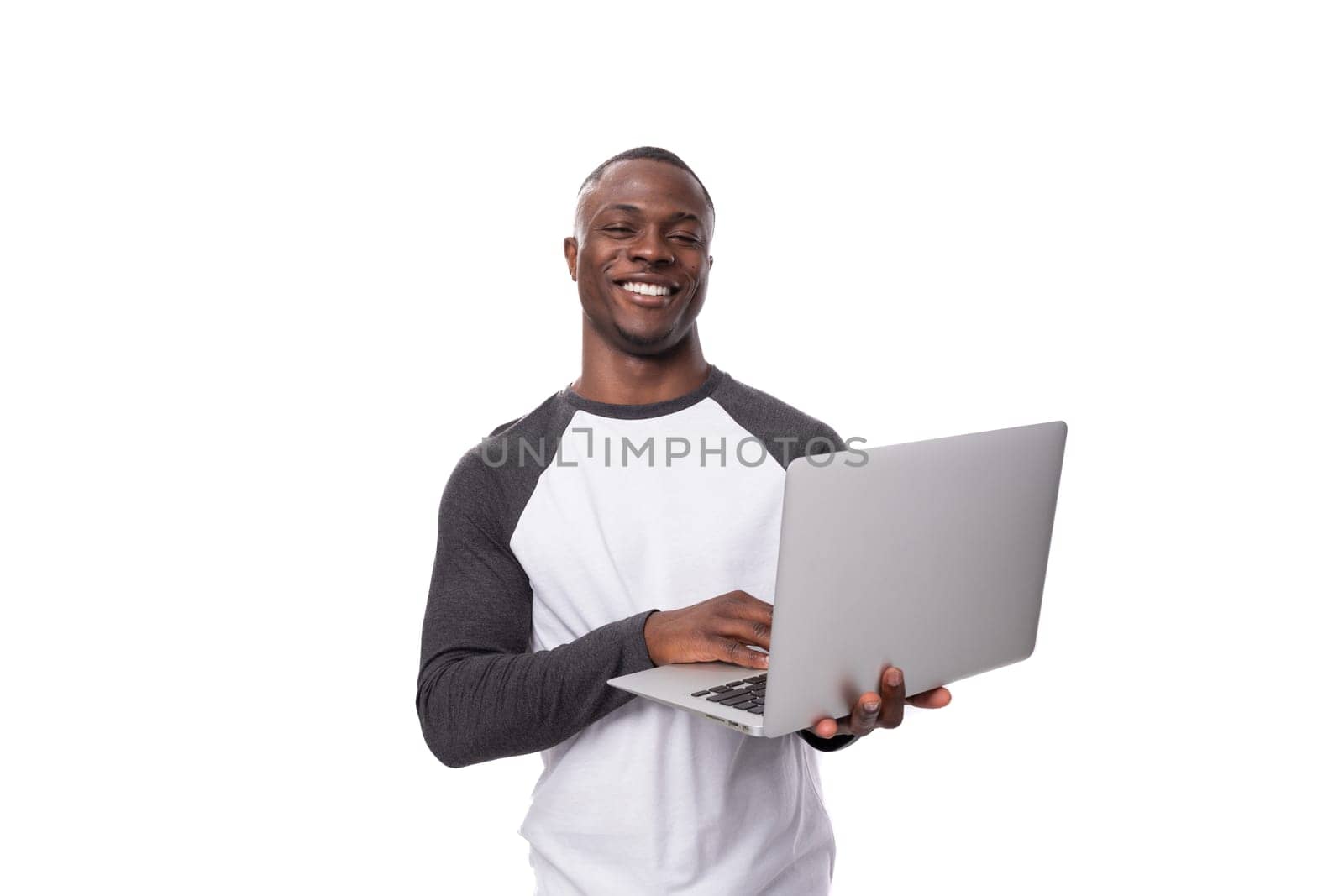 young african man working remotely in the field of IT and using a laptop by TRMK