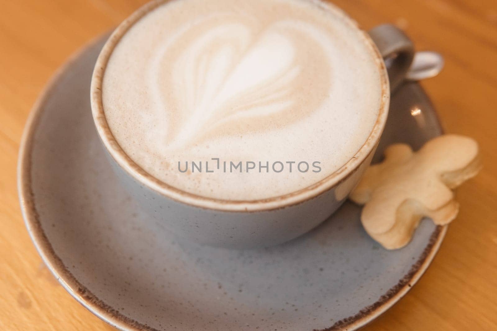 Coffee on a wooden table in a cafe, drawings on coffee