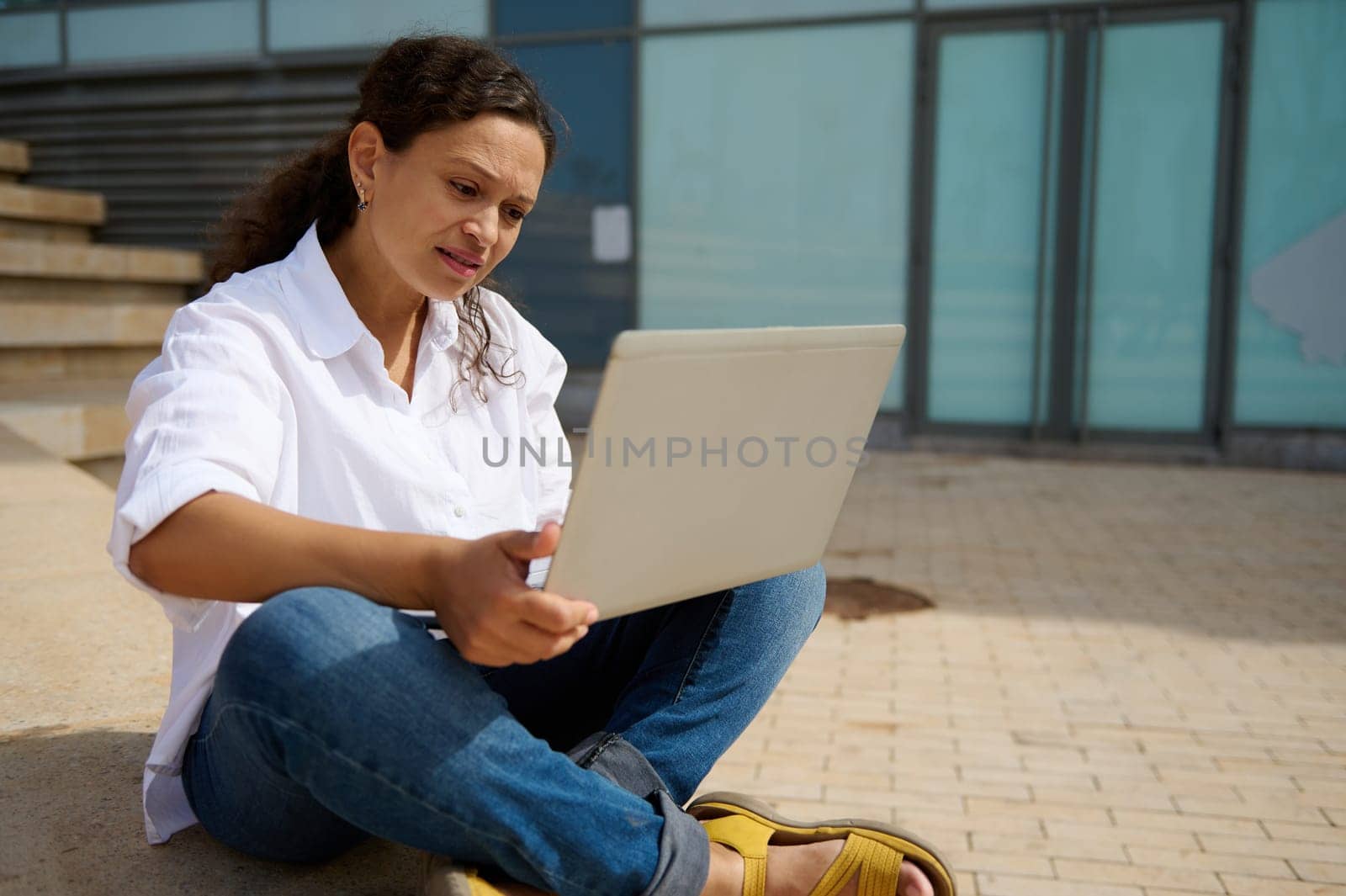 Multitasking businesswoman, entrepreneur, developer, sales manager expressing difficulties, thinking on business development strategy, using laptop, online working. People. Career. Brainstorming