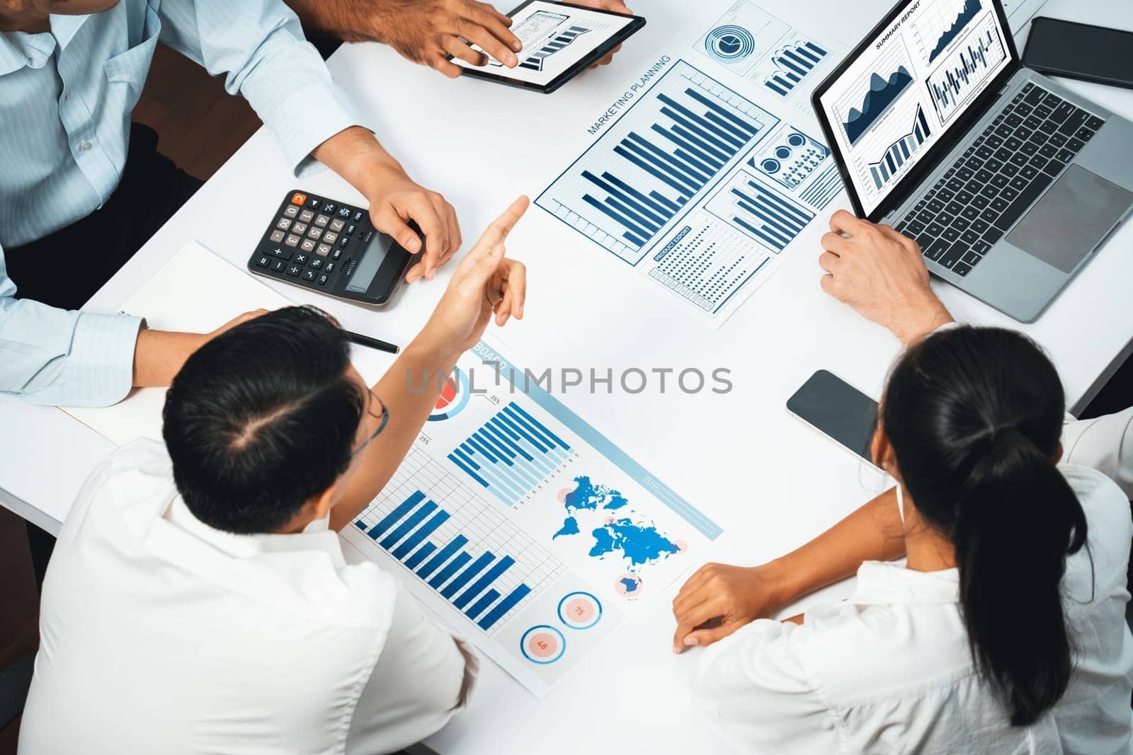 Analyst team utilizing BI Fintech to analyze financial data at table in meeting room. Businesspeople analyzing BI dashboard power on paper for business insight and strategic marketing planning.Prudent