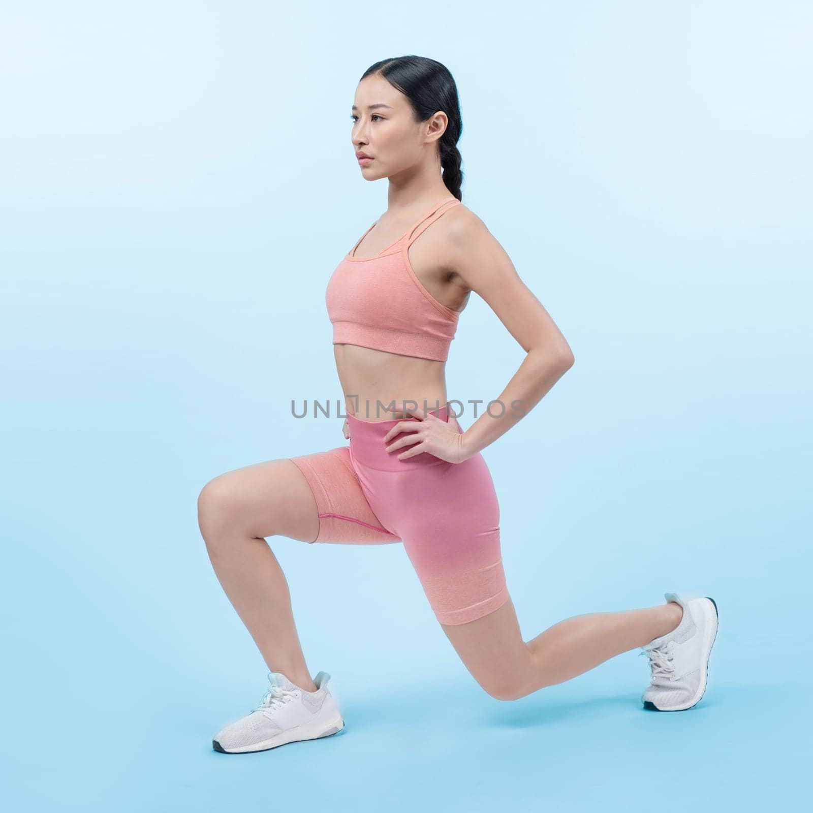 Young attractive asian woman in sportswear stretching. Vigorous by biancoblue