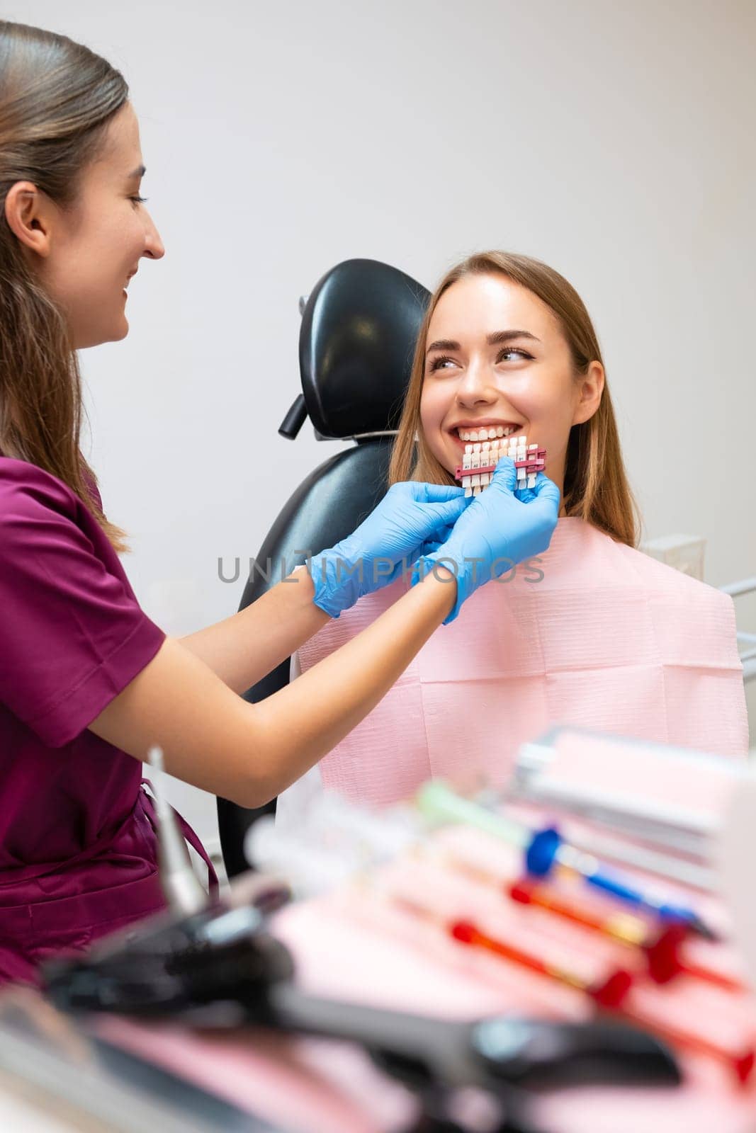 The dentist chooses the ideal shades of white to enhance the patients smile.