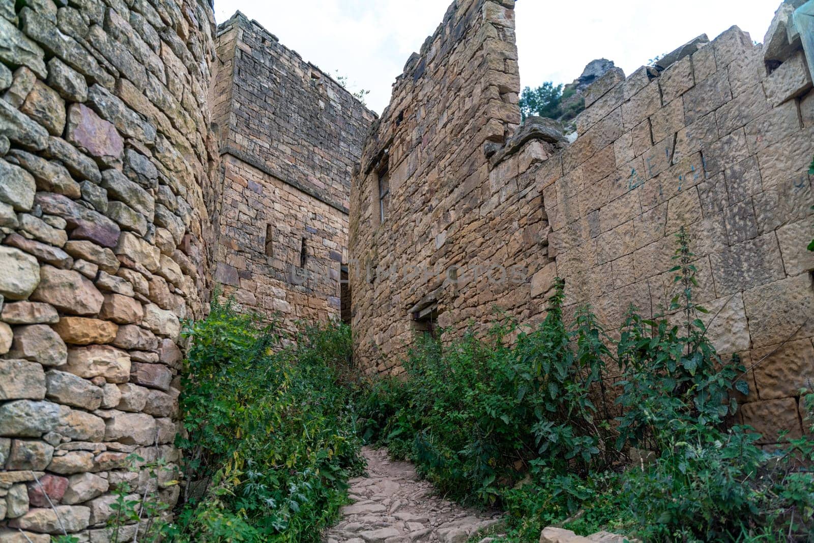 Dagestan Gamsutl. Ancient ghost town of Gamsutl old stone houses in abandoned Gamsutl mountain village in Dagestan, Abandoned etnic aul, summer landscape