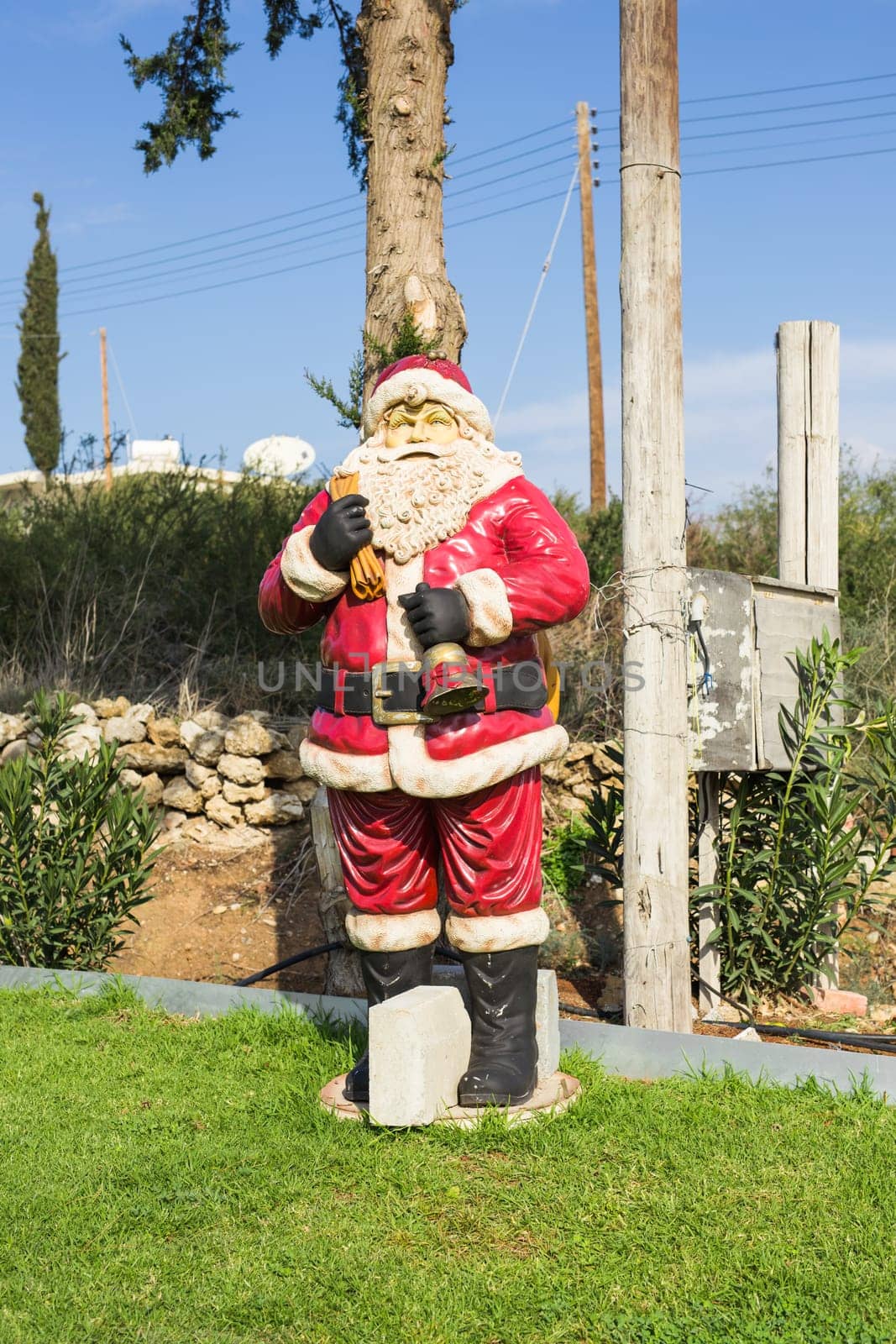 Santa Claus doll. Santa statue with christmas decoration on green grass. by Satura86