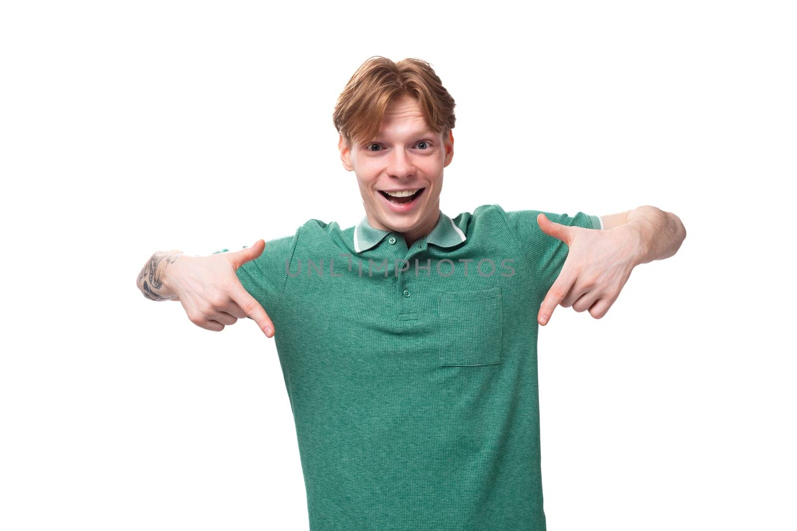 a young slender ginger man with a tattoo on his arm, dressed in a green T-shirt with bright facial expressions by TRMK