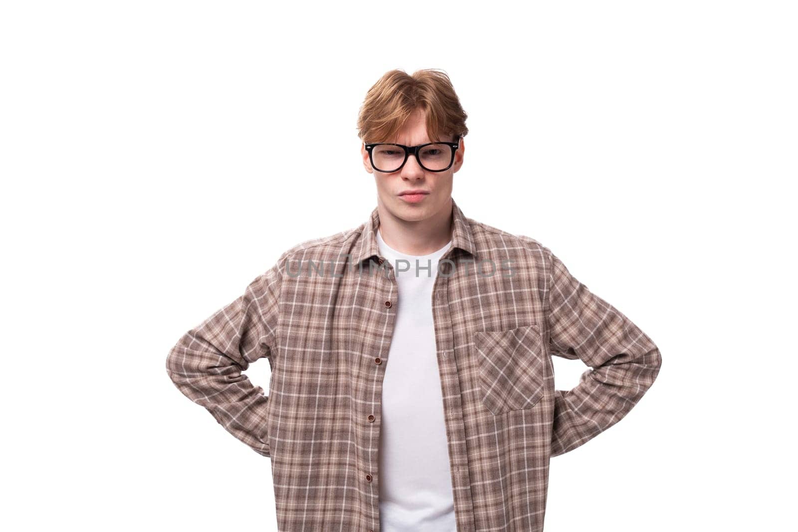 young stylish european student man with golden hair wearing glasses and a plaid shirt.