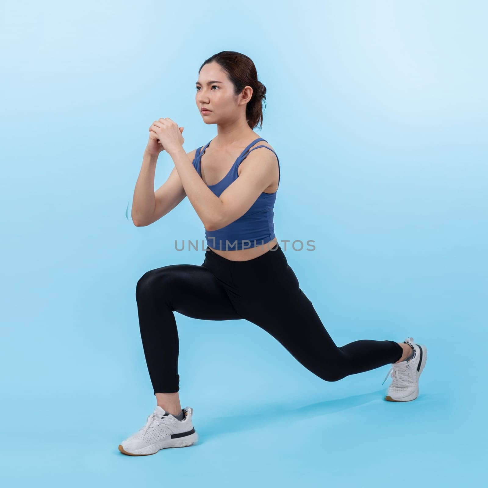 Young attractive asian woman in sportswear stretching before fitness exercise routine. Healthy body care workout with athletic woman warming up on studio shot isolated background. Vigorous