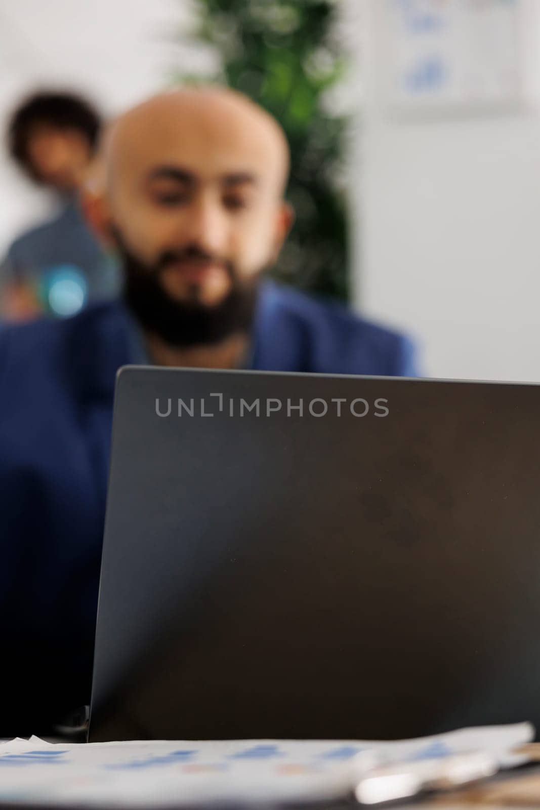 Arab company entrepreneur attending video call investor using laptop by DCStudio