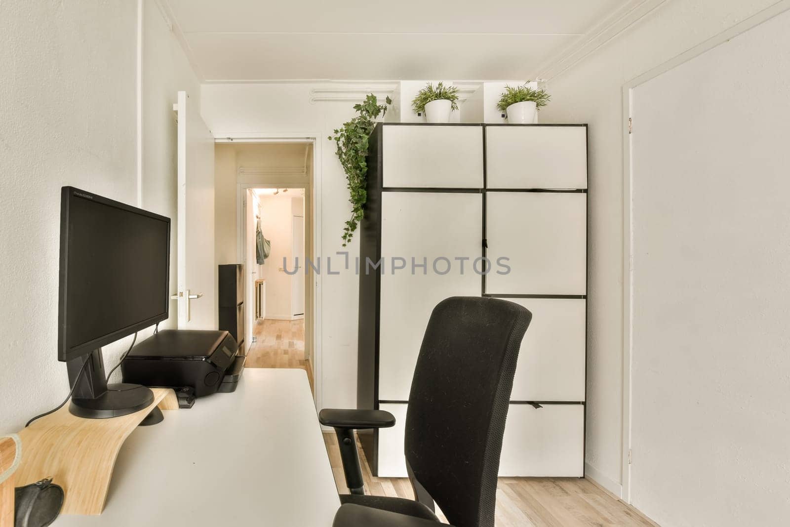 a living room with a white desk and a computer by casamedia