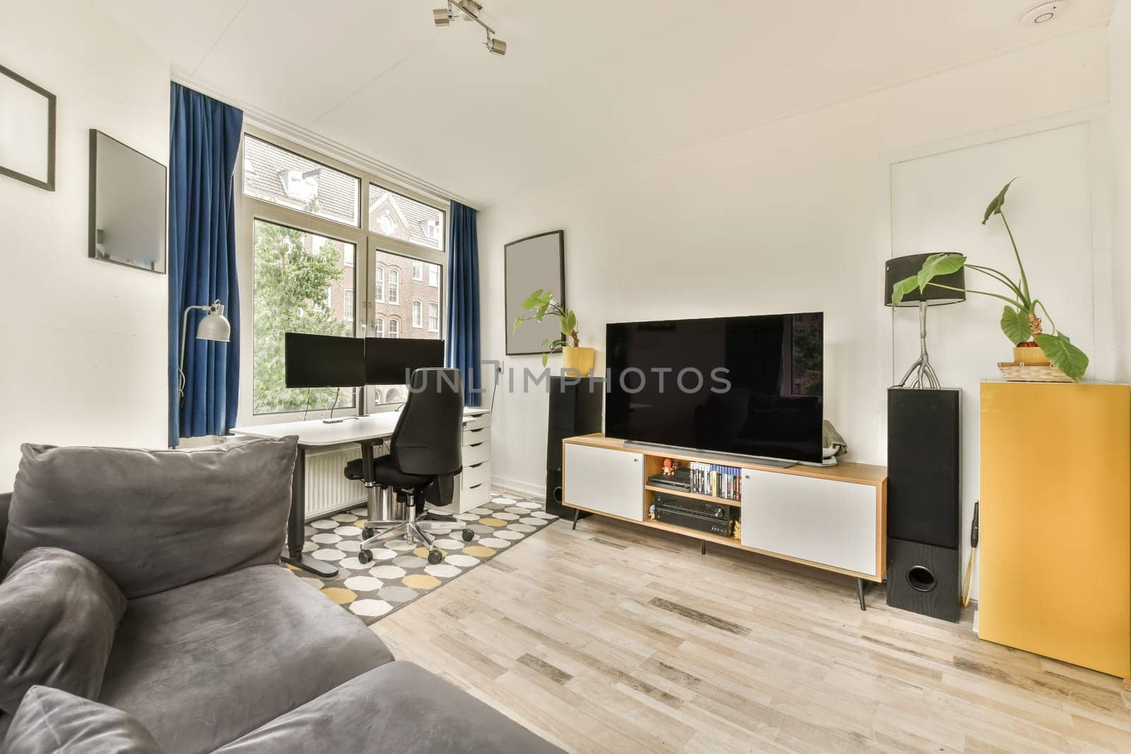 a living room with a couch, tv and other items on the floor in front of the sofa is an entertainment center