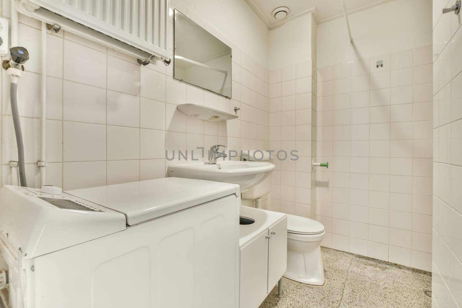 a white bathroom with a sink toilet and shower by casamedia