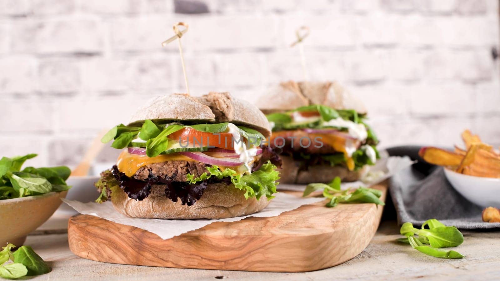 Healthy vegan burger with fresh vegetables and yogurt sauce by homydesign