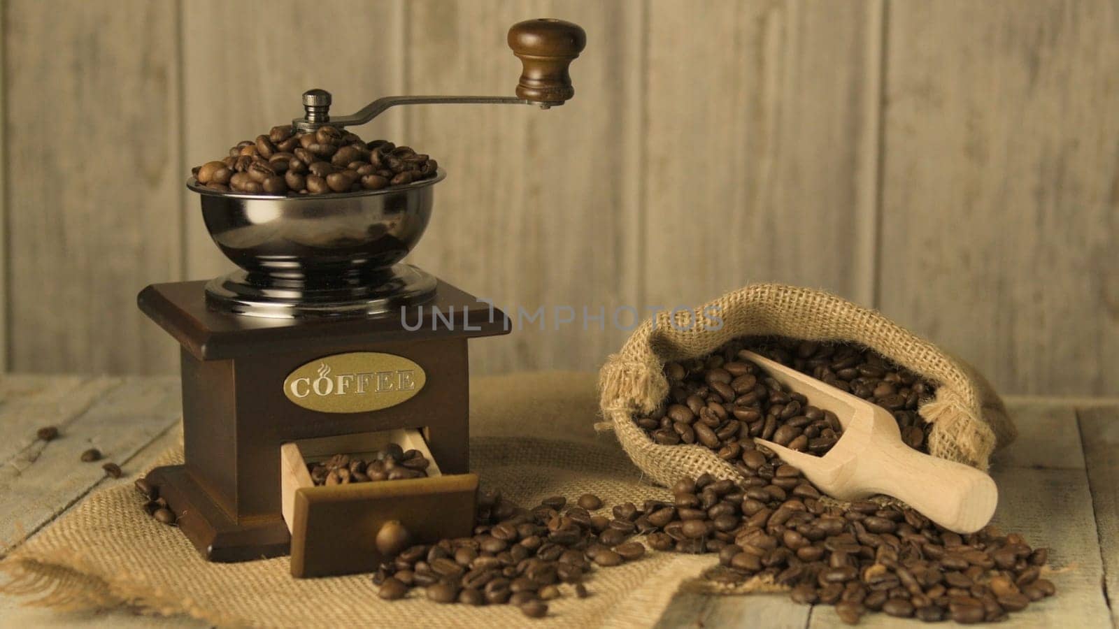Coffee beans on old fashioned wooden table.