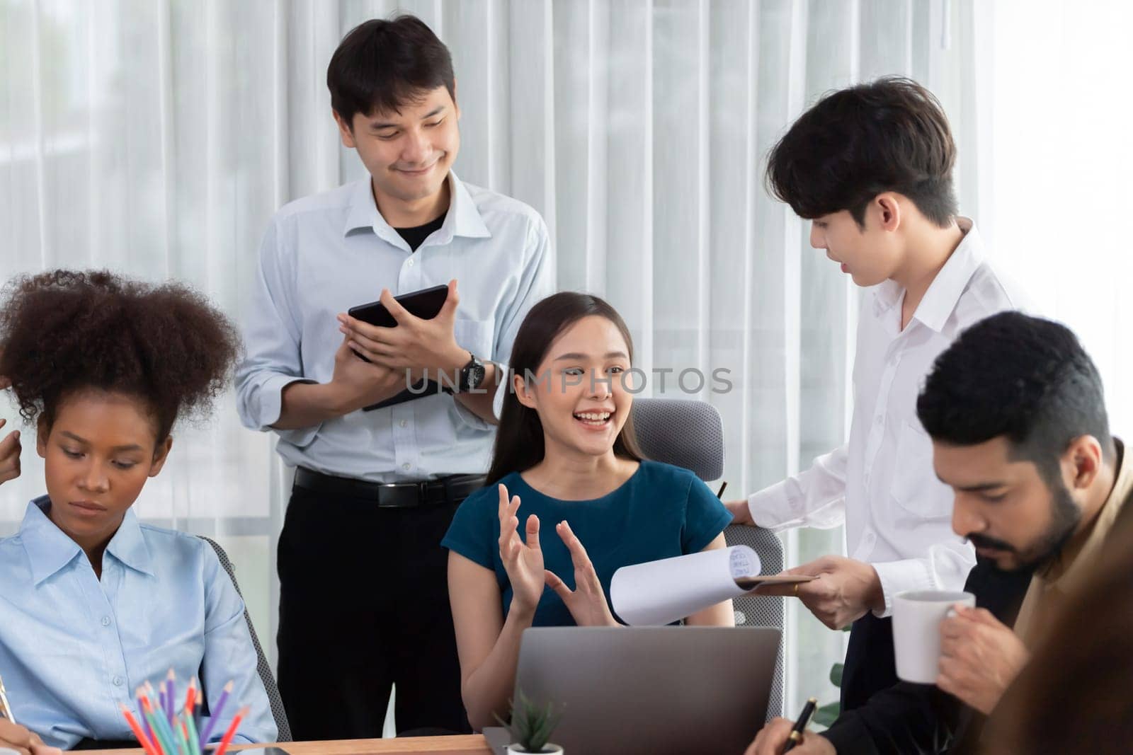 Happy diverse business people work together, discussing in corporate office. Professional and diversity teamwork discuss business plan on desk with laptop. Modern multicultural office worker. Concord