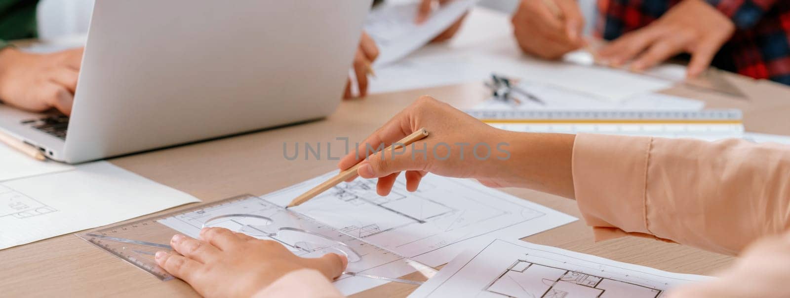 Professional architect drawing blueprint during meeting. Closeup. Delineation by biancoblue
