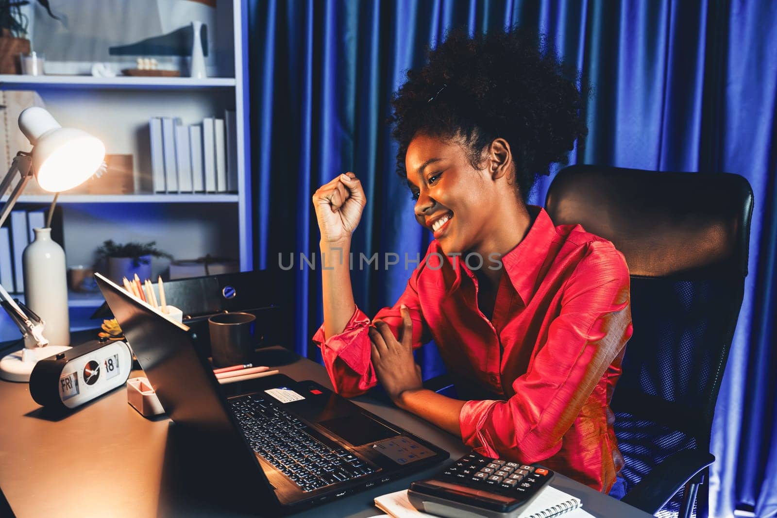 Working African woman with happy glowing, smiling face, getting new job project with good deal or marketing course scholarship information on laptop screen. Concept of cheerful expression. Tastemaker.