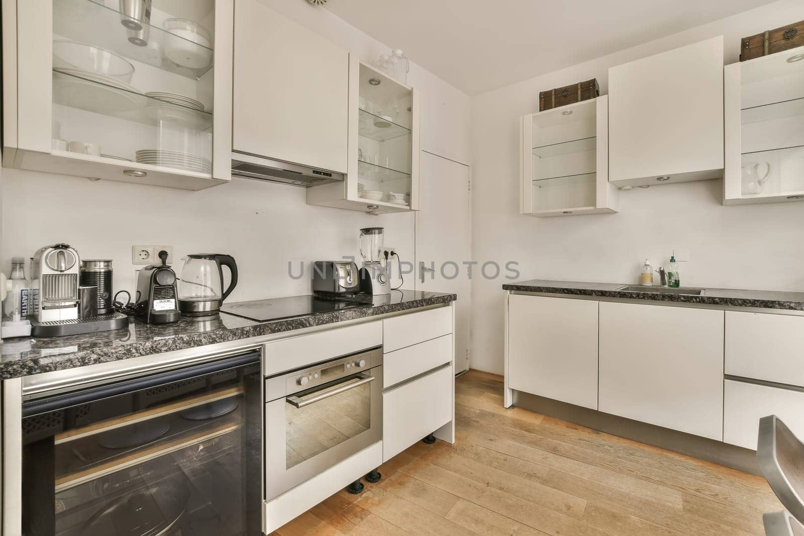 a kitchen with white cupboards and black counter tops on the stove in this photo is taken from the inside