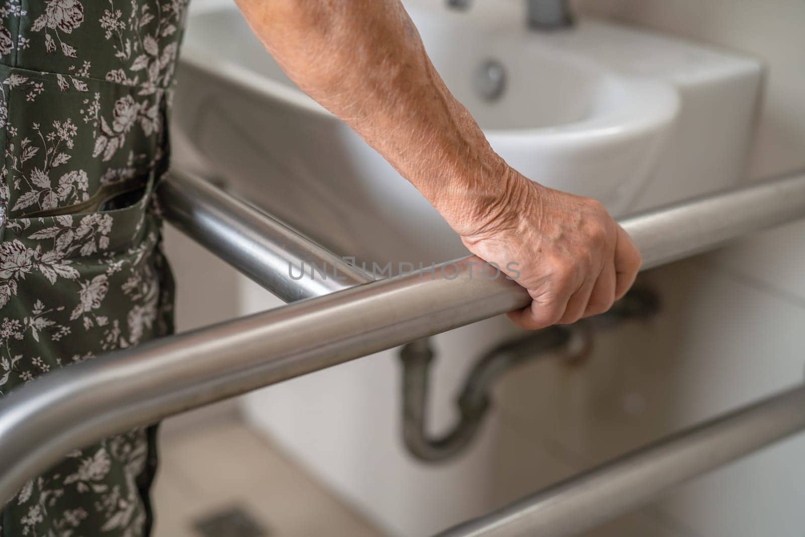 Asian elderly woman patient use toilet bathroom handle security in nursing hospital, healthy strong medical. by pamai