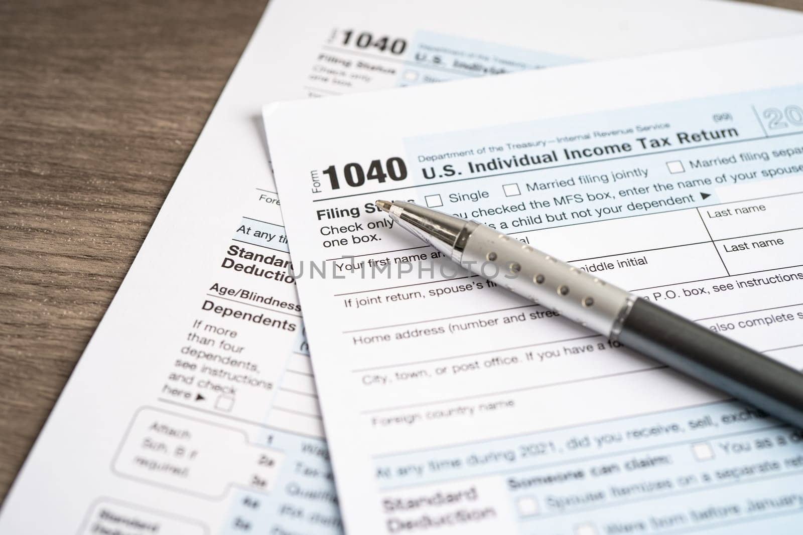Tax Return form 1040 with pen, U.S. Individual Income. by pamai