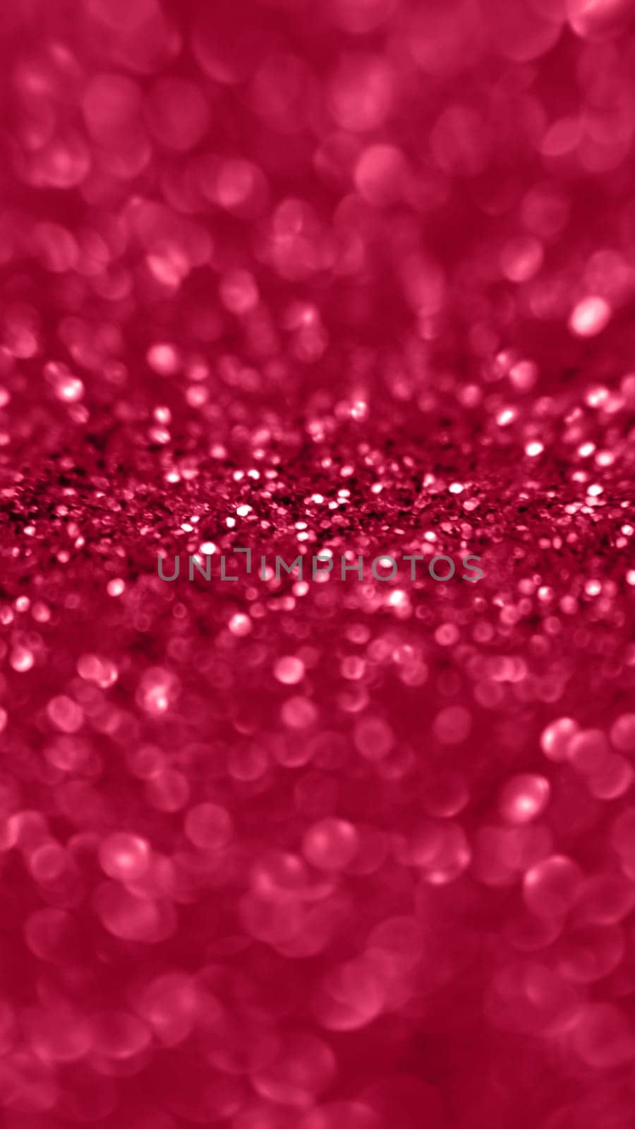 Golden color glitter background. Blurred monochrome background with bokeh. Blurred glitters shimmering dust macro close up.