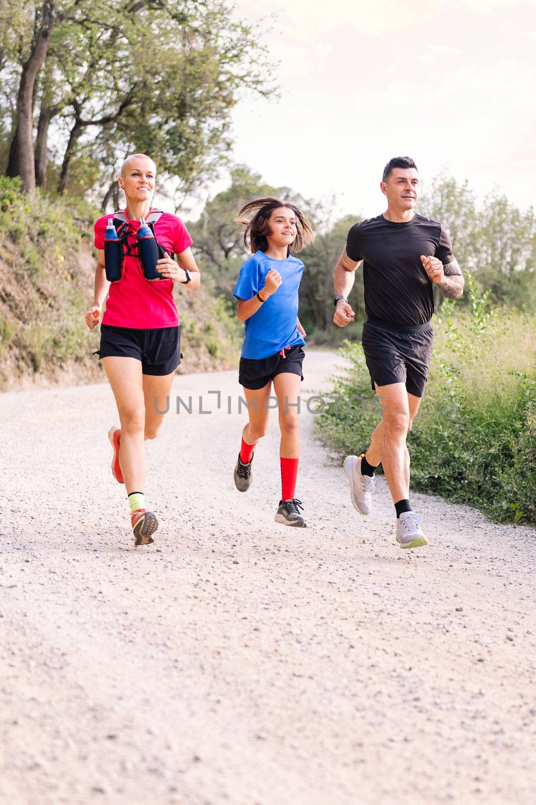 family practicing trail running in the countryside by raulmelldo