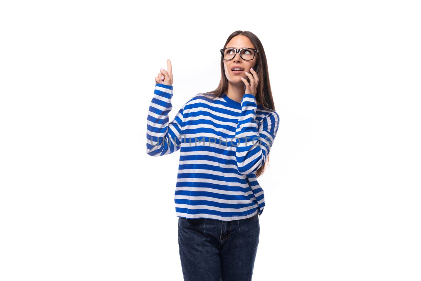 positive smiling young brunette woman in glasses talking on the phone.