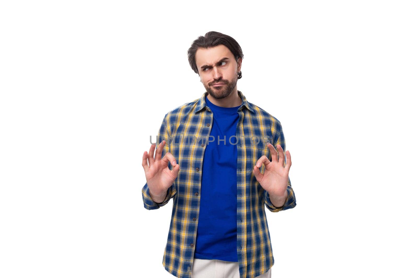 young caucasian brutal man with unshaven face dressed in blue plaid shirt isolated on white background with copy space.