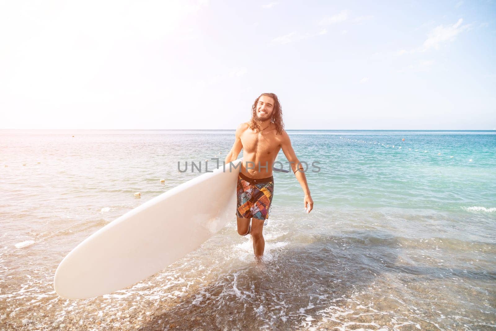 Asian man swimming in sea water and paddleboarding passing beautiful sea at summer sunset. Healthy strong male enjoy outdoor active lifestyle and water sports on holiday vacation