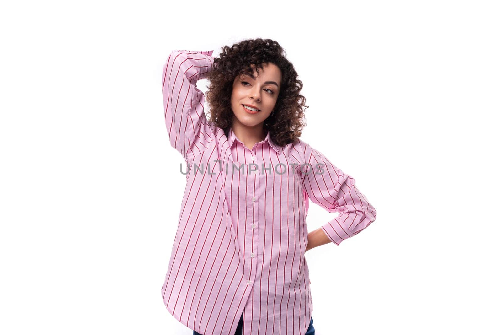 young caucasian leader woman with a curly haircut is dressed in a pink shirt on a white background by TRMK