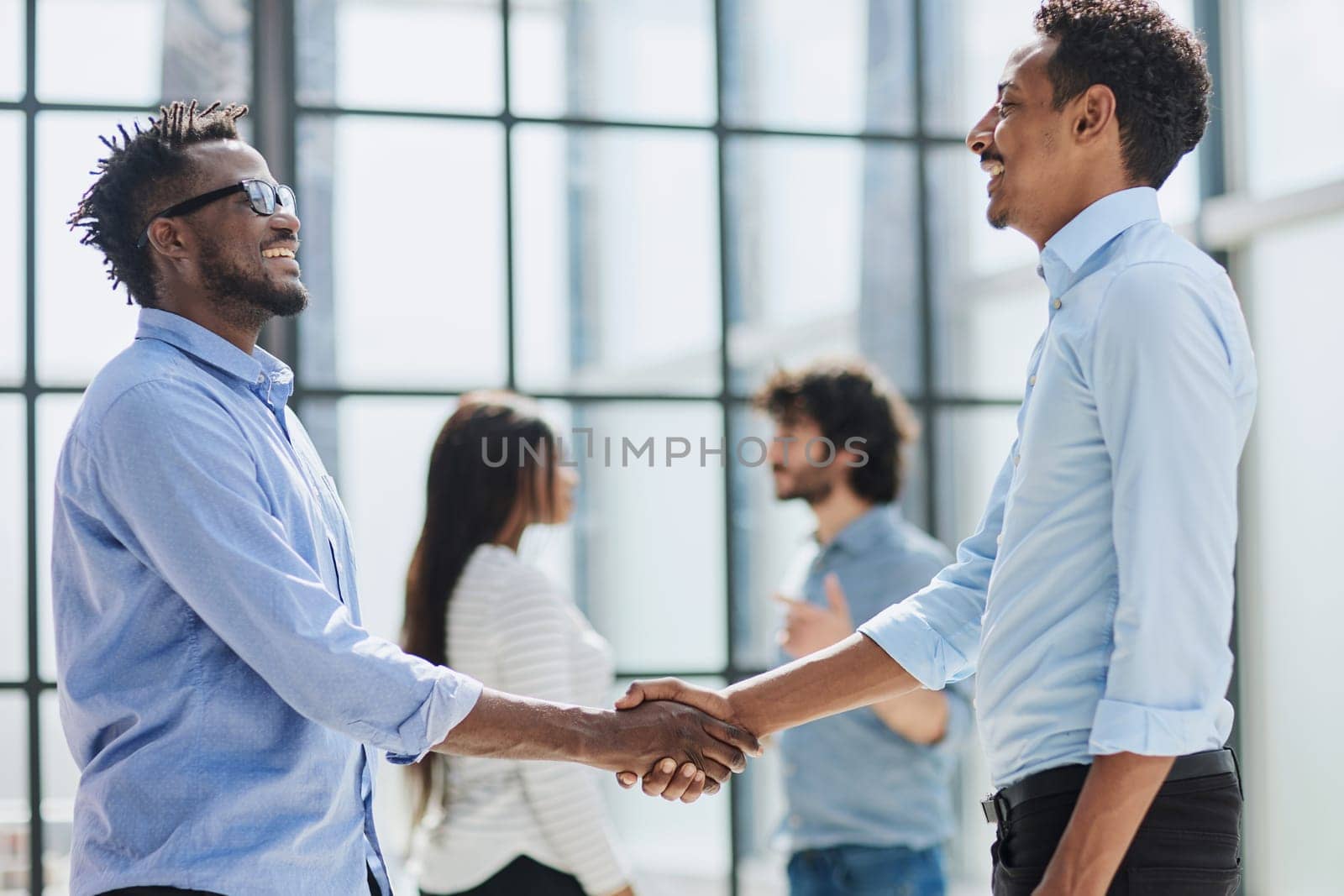 Successful Business Collaboration: Executives Greet with Handshake in Office by Prosto