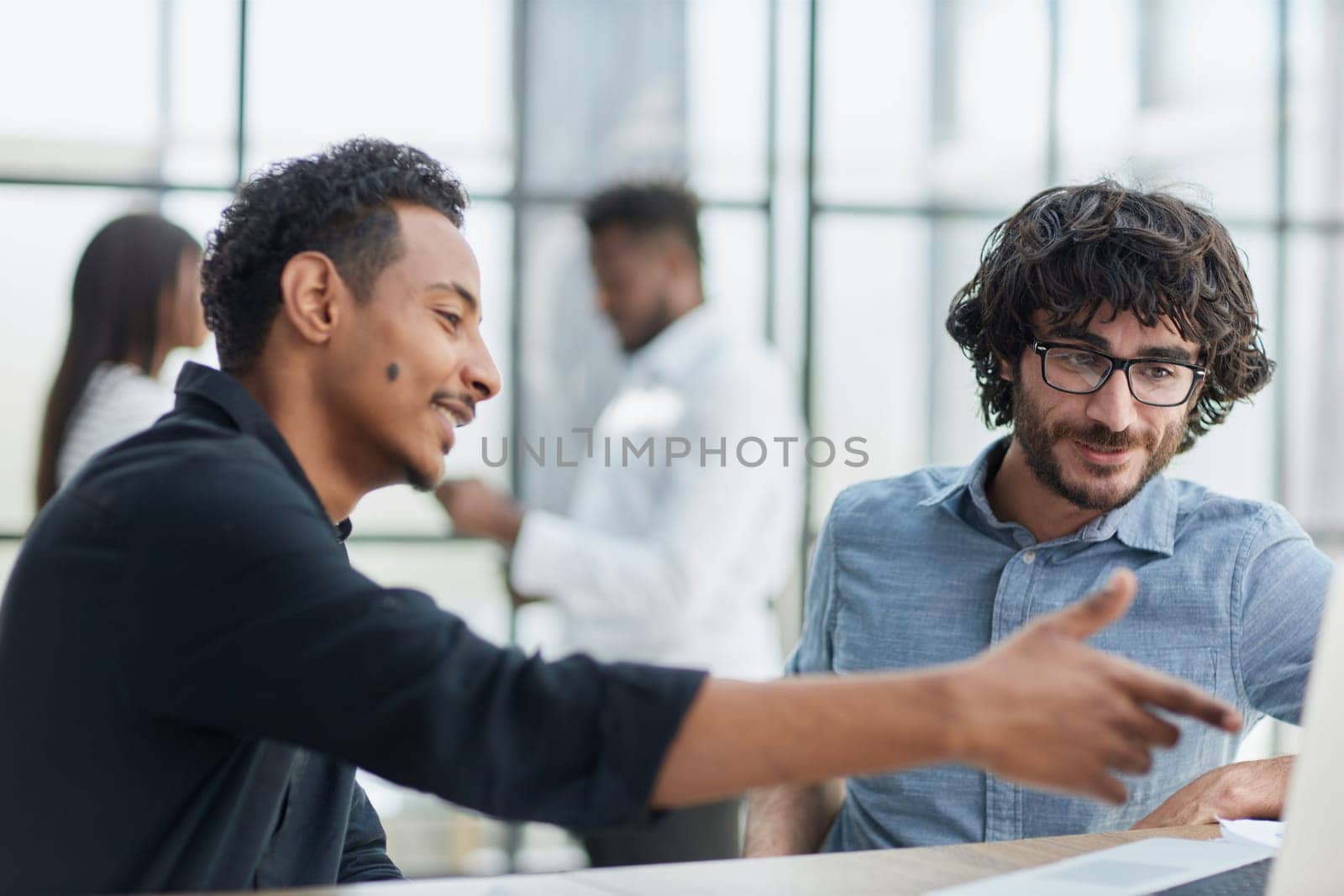 Business professionals collaborating happily in a modern office with technology.